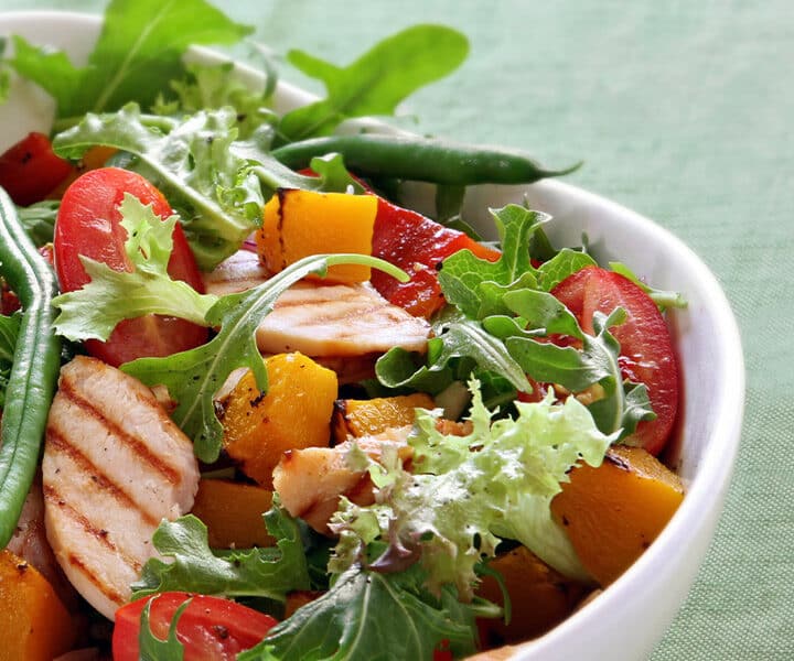 a bowl of salad with meat and vegetables