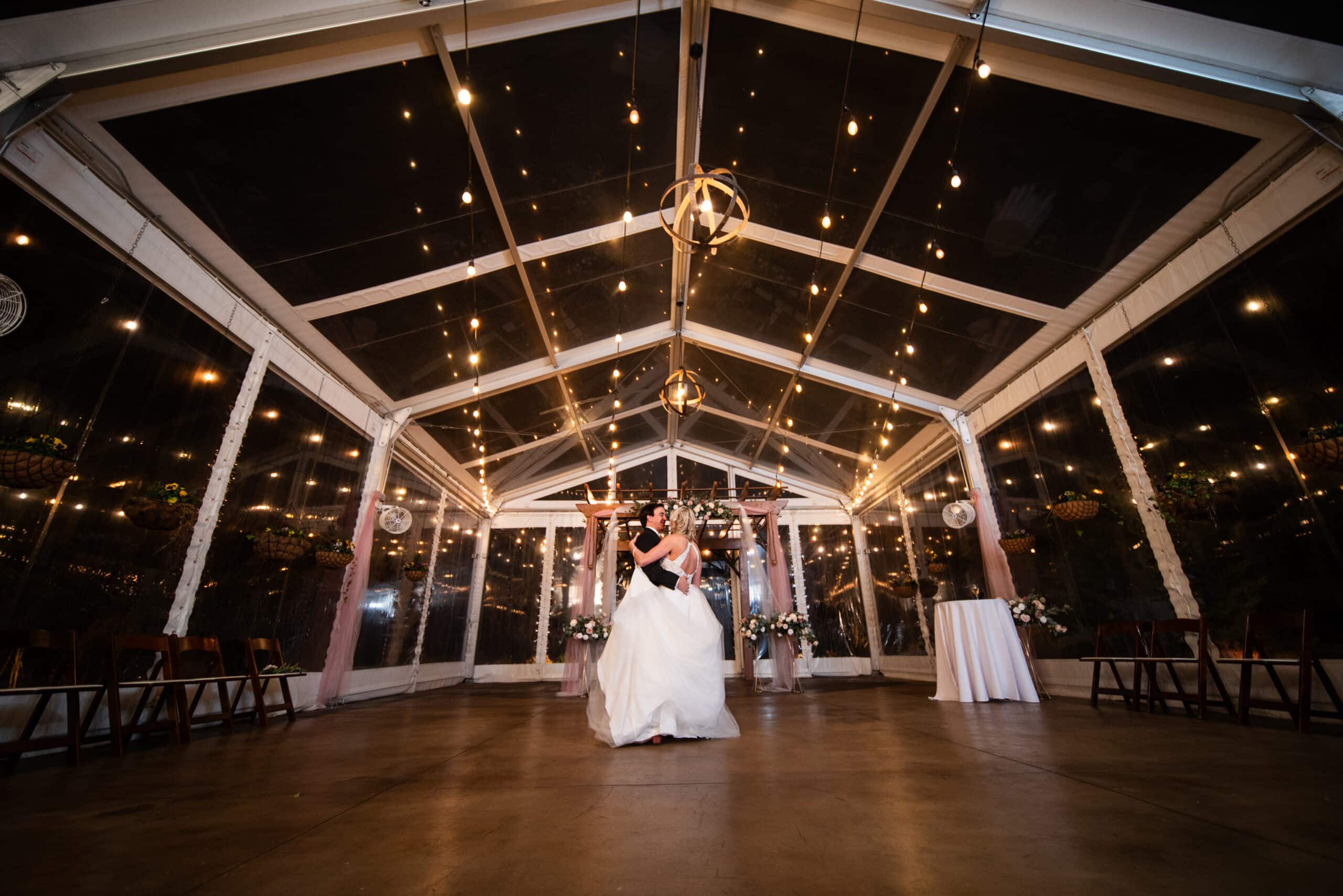 a bride and groom dancing in a room